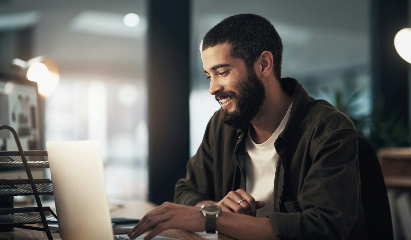 Do more, get more. Shot of a young businessman using a laptop during a late night at work.