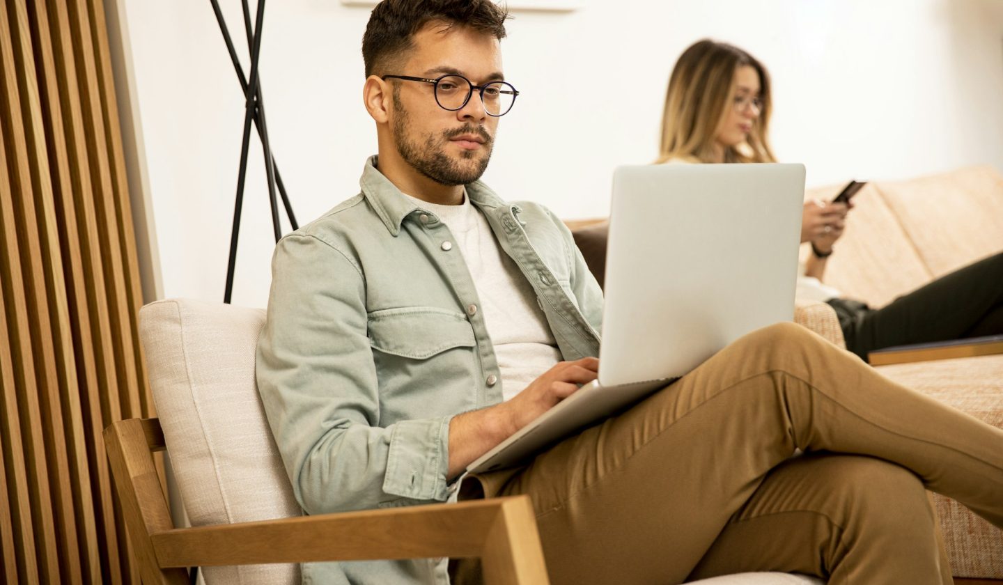 Young man using laptop at home